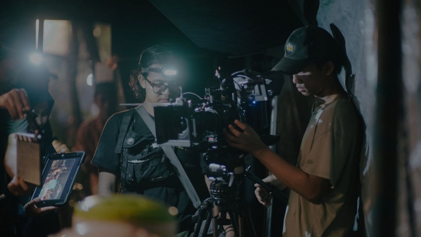 A Fixinema production crew prepares a cinema camera on location.